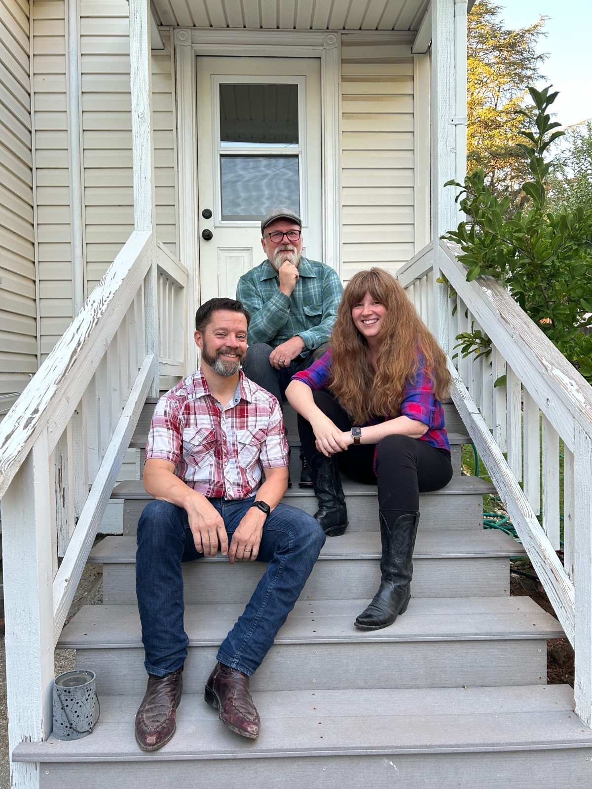 The New Neighbors (Andy, Emily, Scotty) sitting on porch steps